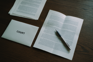 Official court enforcement documents and letter on a wooden desk, representing bailiff action on a County Court Judgment